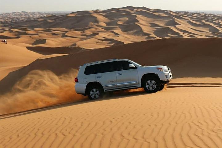 Experience the excitement of dune bashing in a luxury 4x4 surrounded by the stunning landscapes of Dubai's deserts. Adventure awaits in this sandy paradise!